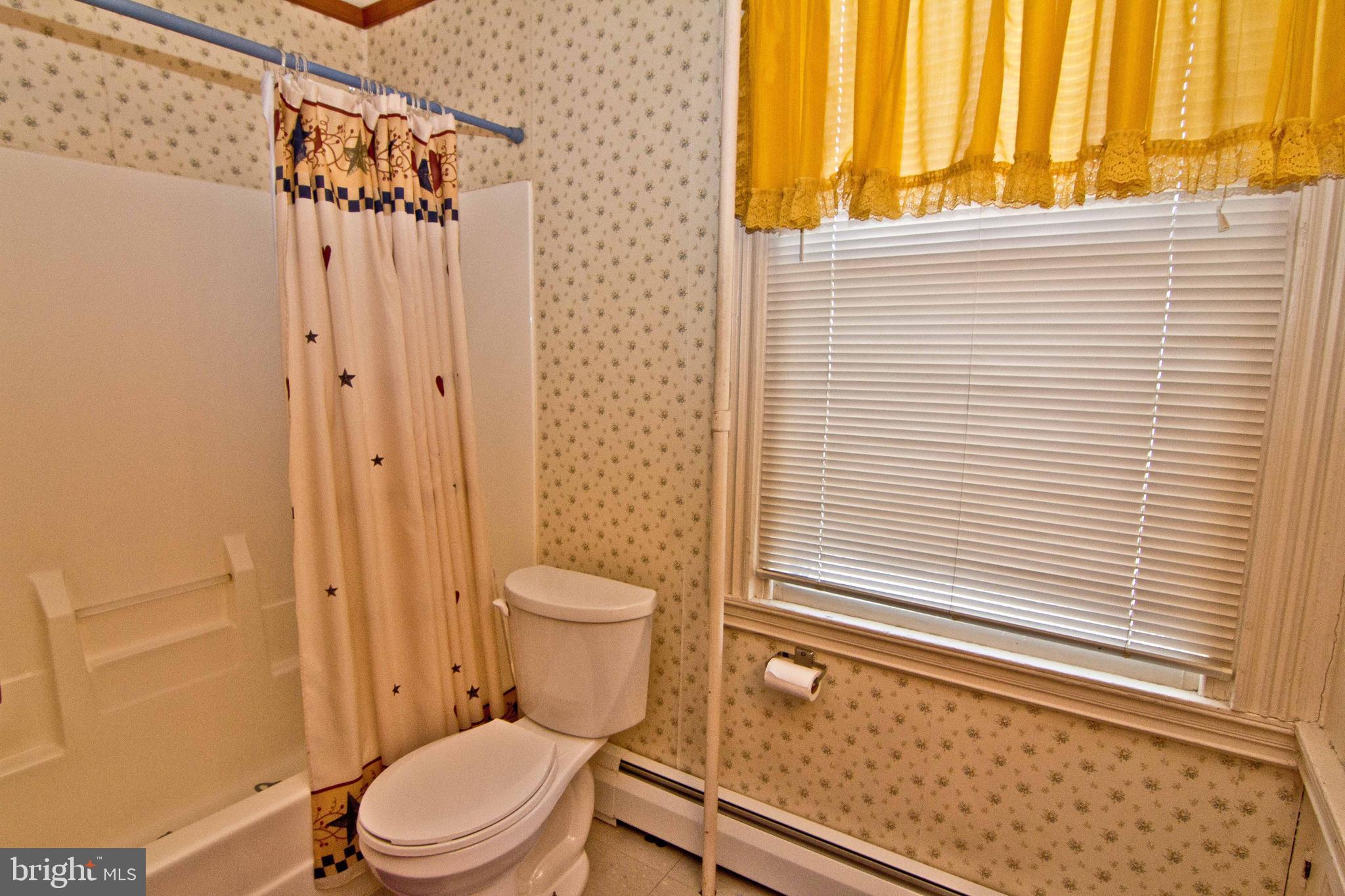 59 Market Street Salem, NJ 08079 - Photo 19 of 21 a bathroom with a toilet a sink and shower