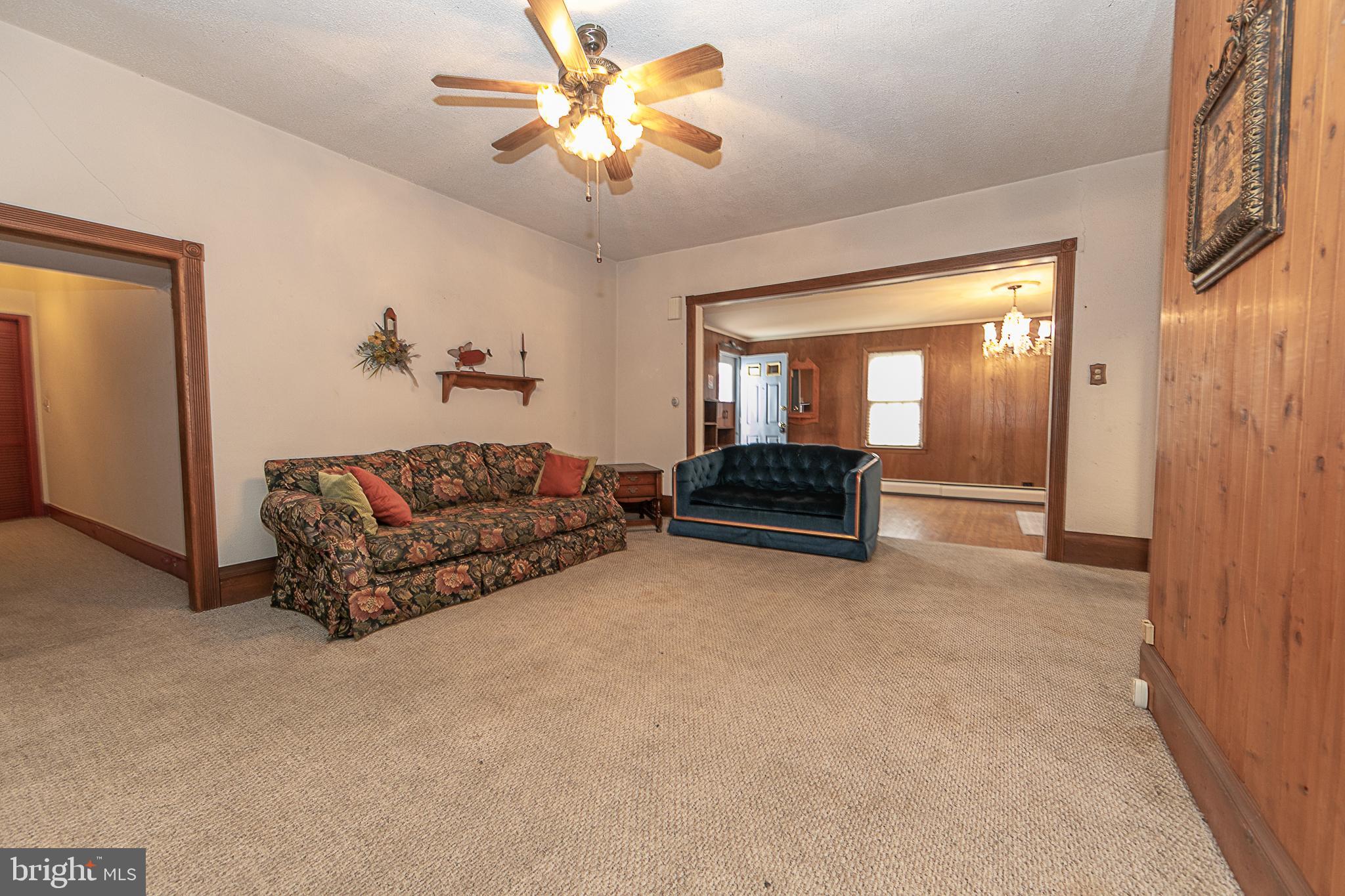 59 Market Street Salem, NJ 08079 - Photo 5 of 21 a living room with furniture and a chandelier