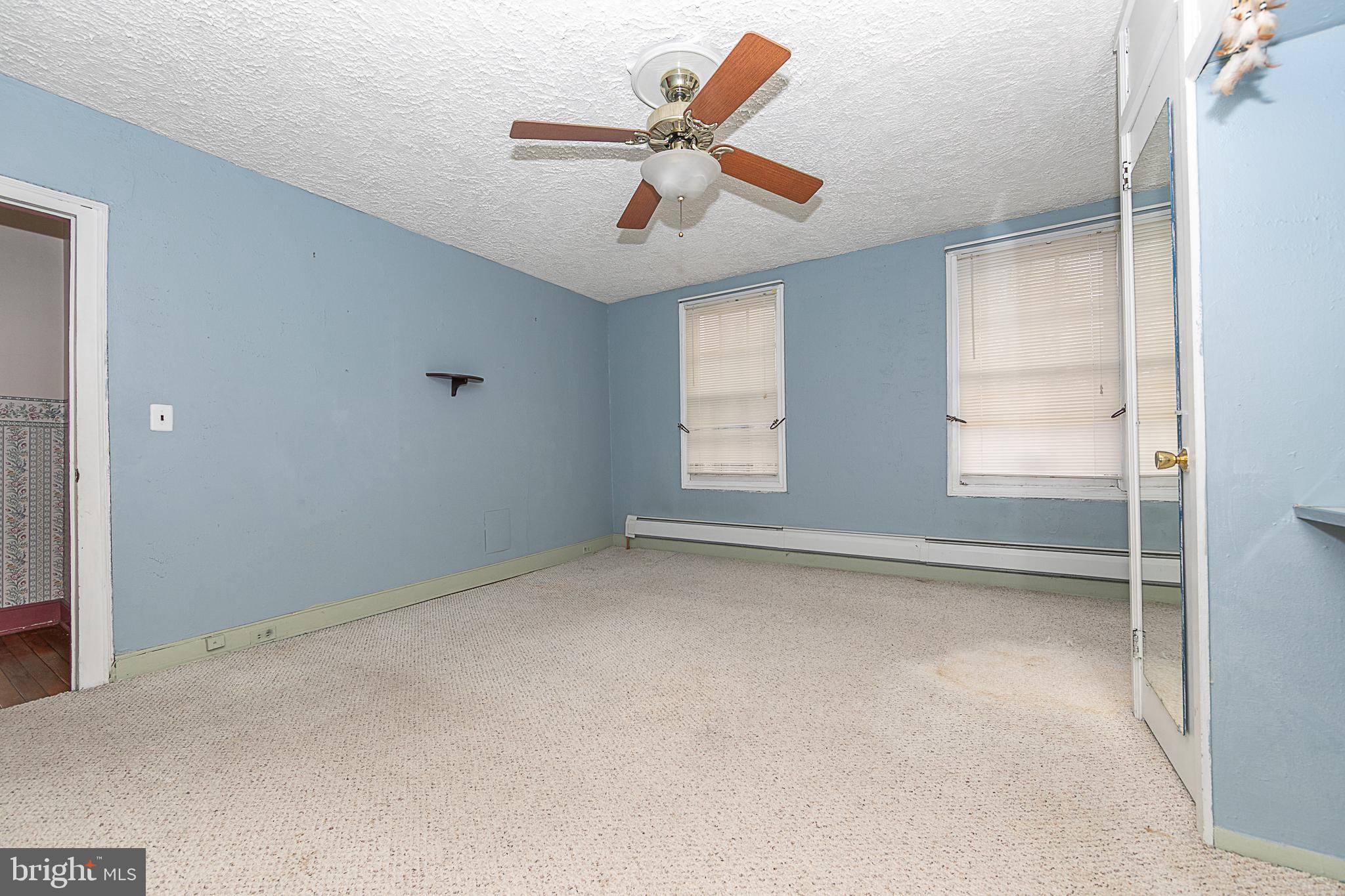 59 Market Street Salem, NJ 08079 - Photo 9 of 21 an empty room with windows and fan