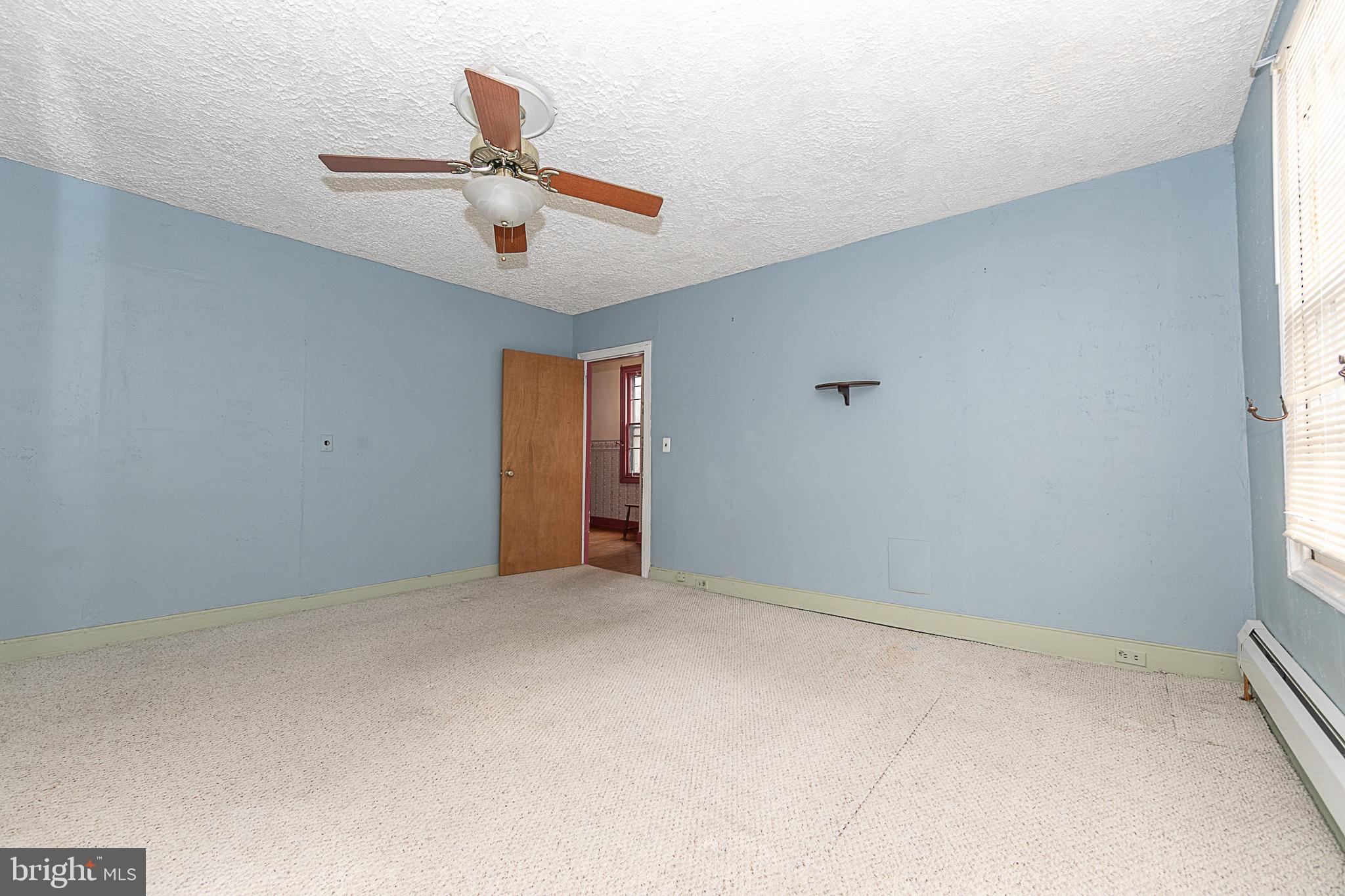 59 Market Street Salem, NJ 08079 - Photo 10 of 21 an empty room with ceiling fan and window