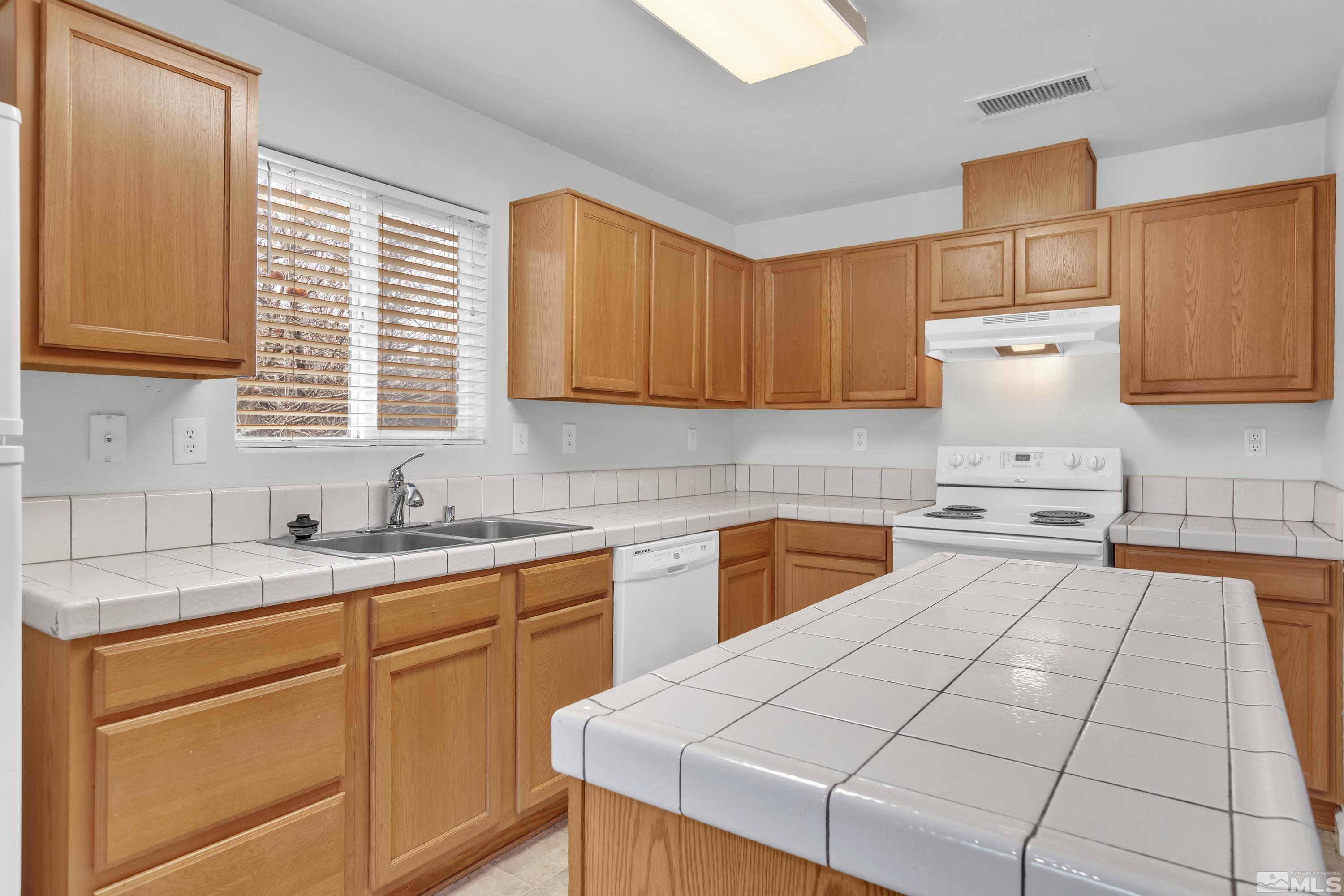 2928 Bryan Street Reno, NV 89503 - Photo 11 of 37 a kitchen with a white cabinets and white appliances