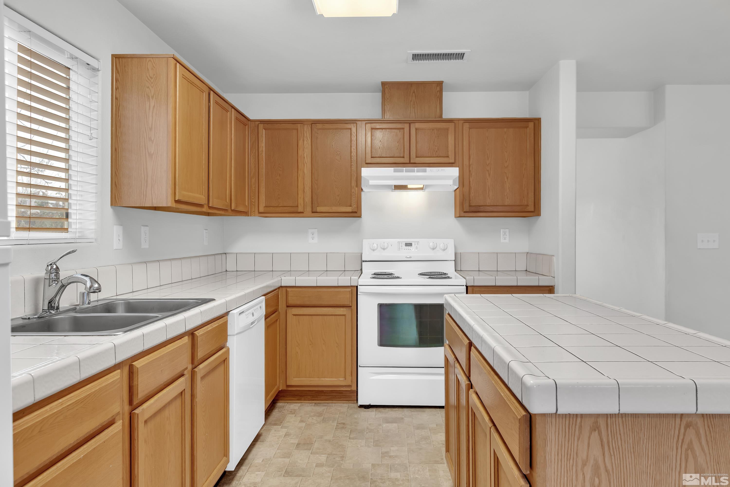 2928 Bryan Street Reno, NV 89503 - Photo 12 of 37 a kitchen with a sink stove and cabinets