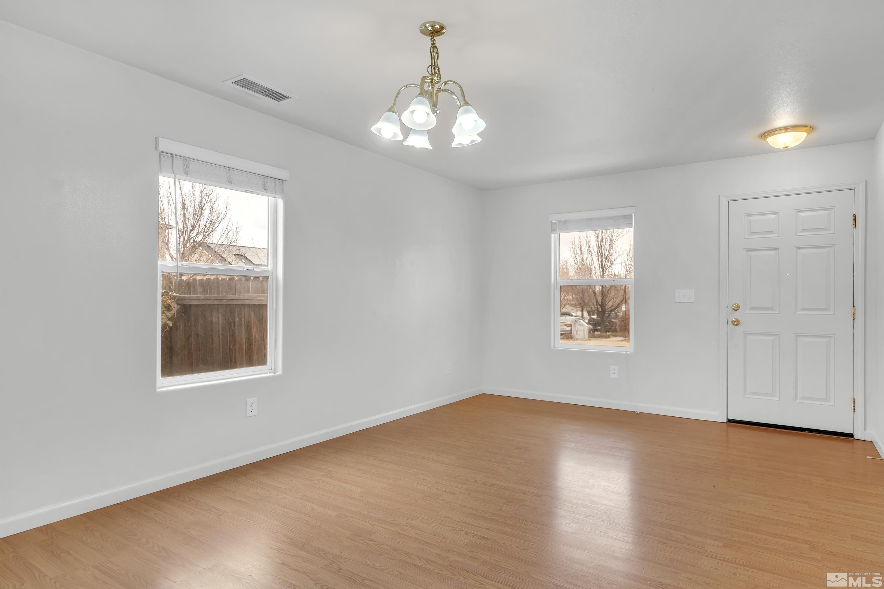 2928 Bryan Street Reno, NV 89503 - Photo 4 of 37 a view of an empty room with wooden floor and a window
