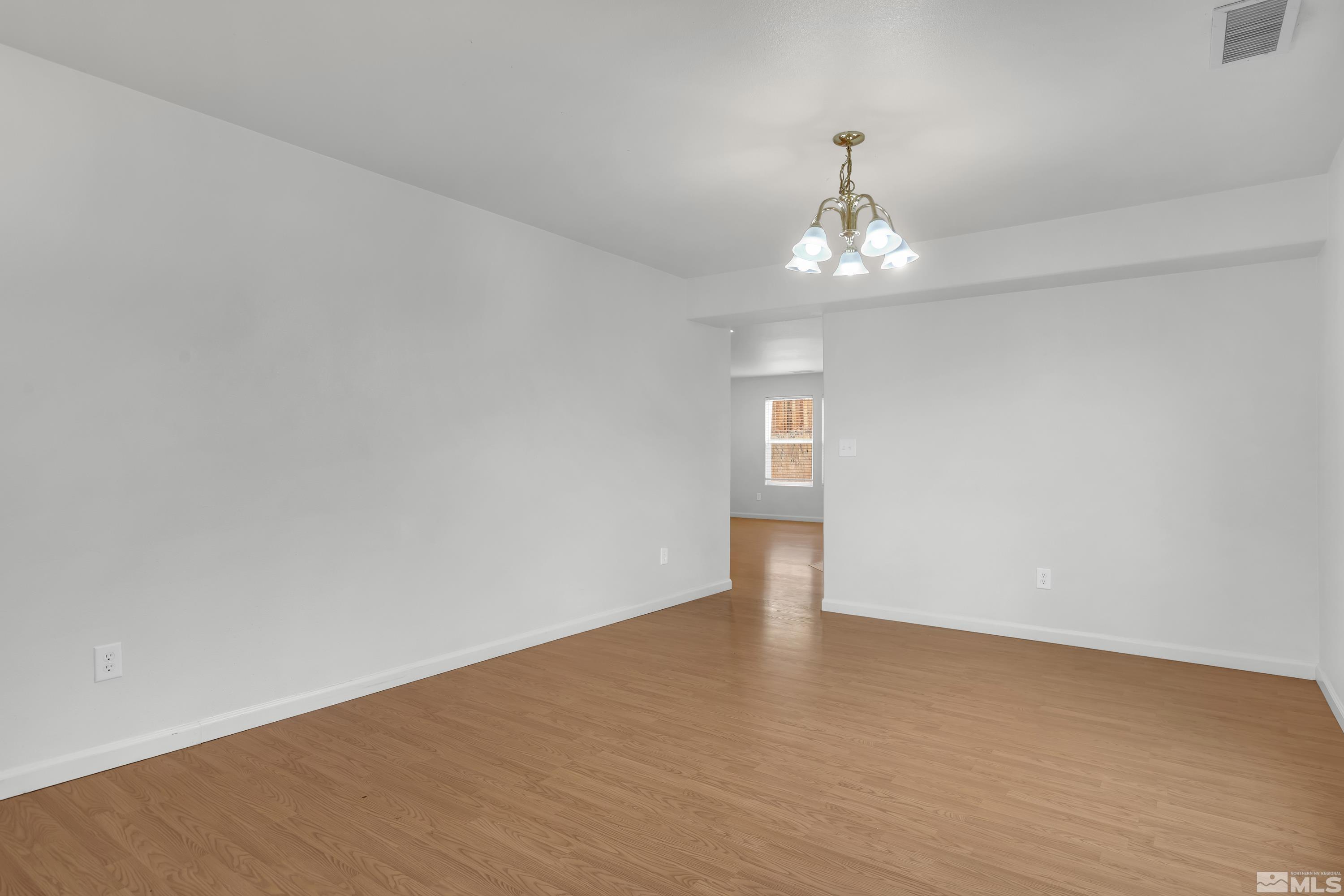 2928 Bryan Street Reno, NV 89503 - Photo 5 of 37 wooden floor in an empty room with a window