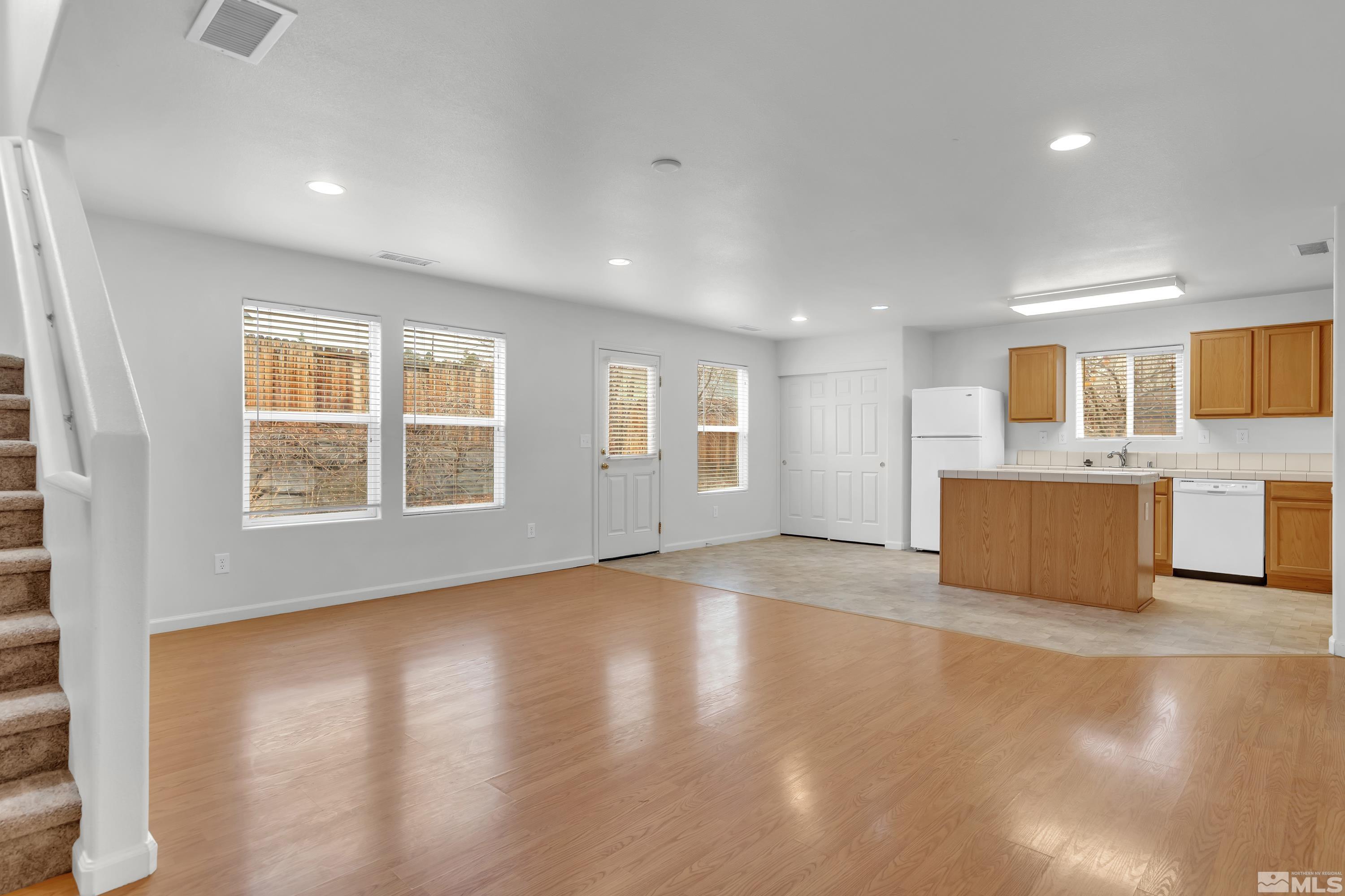 2928 Bryan Street Reno, NV 89503 - Photo 7 of 37 a view of an empty room with a window and wooden floor