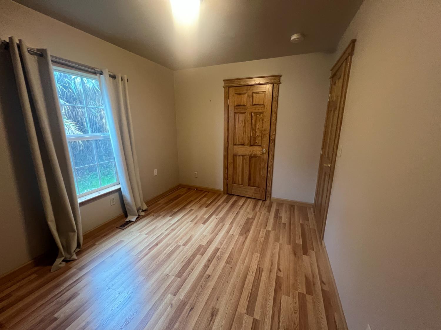 312 South Church Street Ione, CA 95640 - Photo 14 of 22 a view of empty room with wooden floor and fan