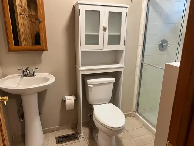 a bathroom with a sink toilet and a mirror