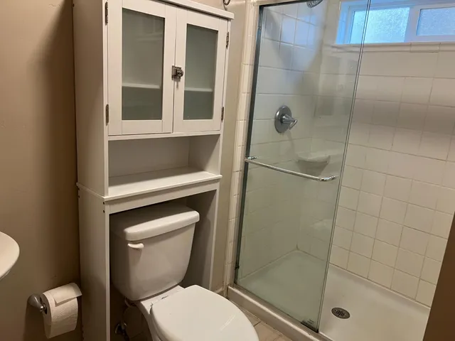 a bathroom with a toilet and a shower