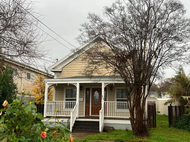 a front view of a house with a garden