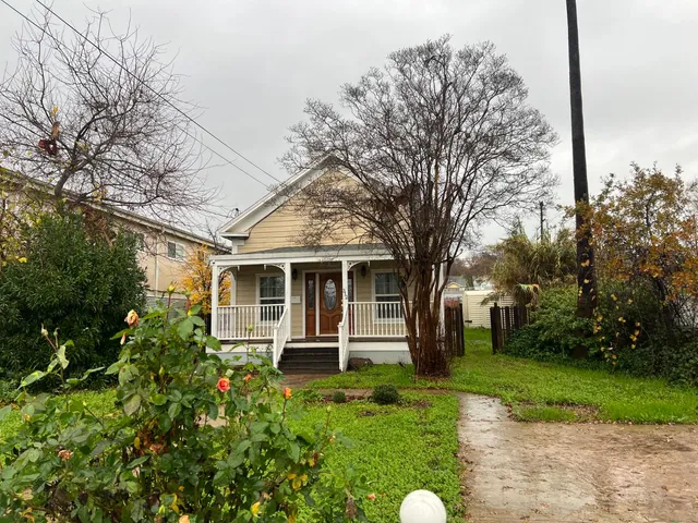 a front view of house with yard and green space