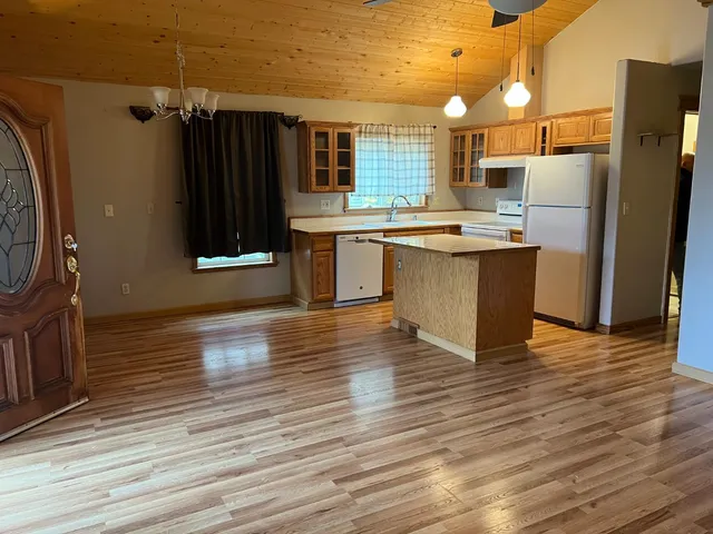 a kitchen with granite countertop a refrigerator and a stove