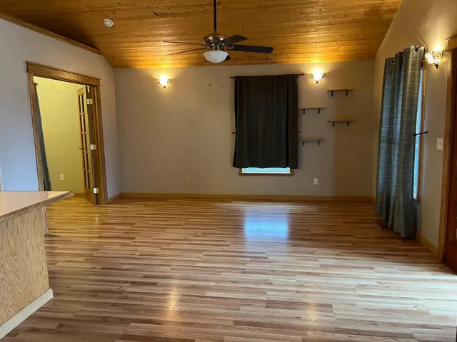 a view of a room with wooden floor