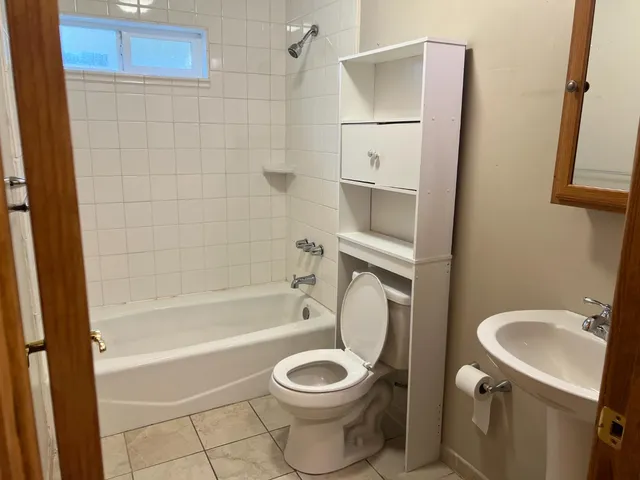 a bathroom with a toilet sink and shower
