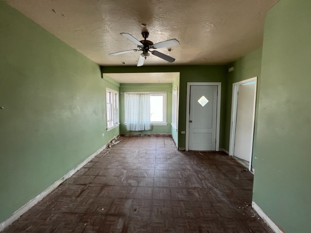 305 153rd Street Calumet City, IL 60409 - Photo 17 of 40 a view of a hallway with a chandelier fan and windows