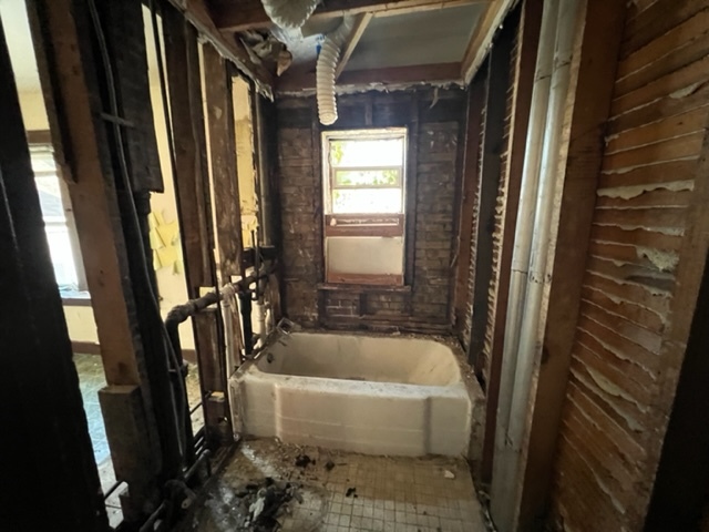 305 153rd Street Calumet City, IL 60409 - Photo 8 of 40 a white bath tub sitting in a bathroom next to a window