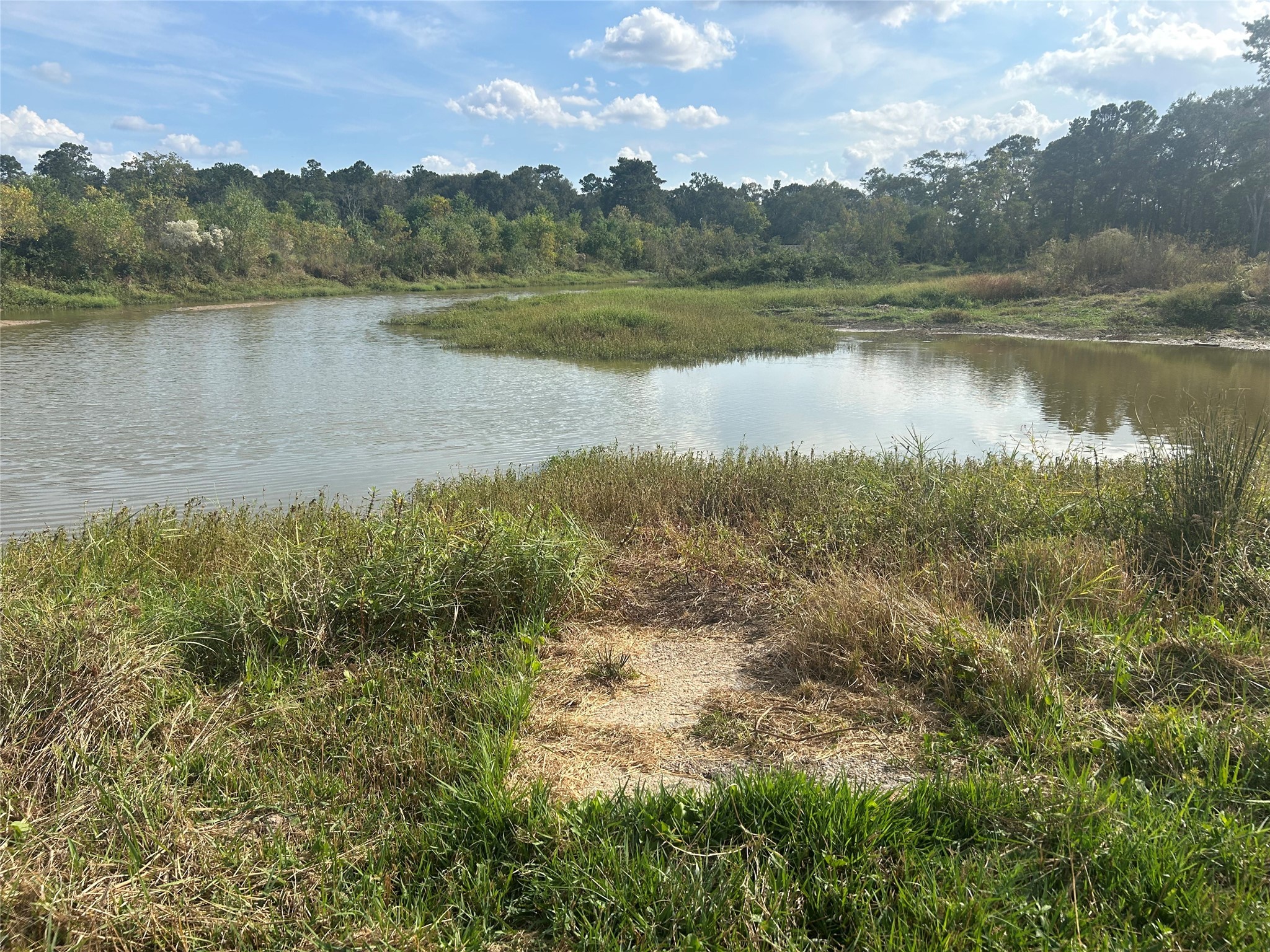 18074 Hill Road Cleveland, TX 77328 - Photo 12 of 19 a view of a lake with a city