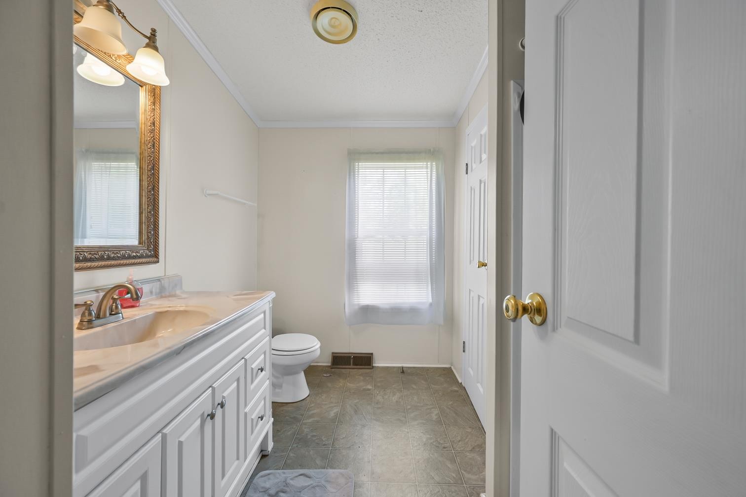 6439 Cedar Grove Road Big Sandy, TN 38221 - Photo 18 of 38 a bathroom with a sink and a mirror