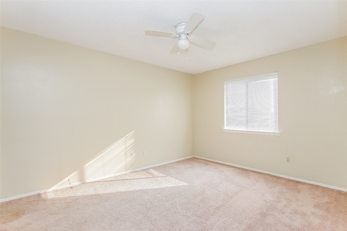 1813 Rawhide Drive Round Rock, TX 78681 - Photo 11 of 16 an empty room with a window and a ceiling fan