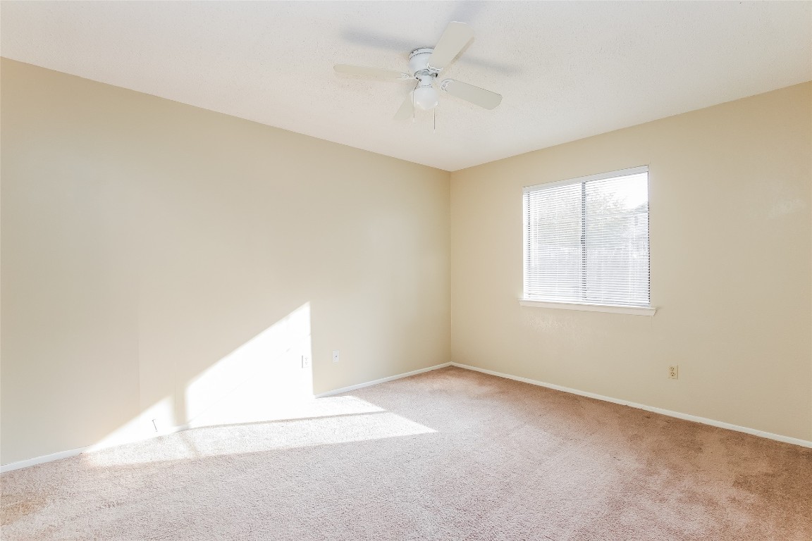 1813 Rawhide Drive Round Rock, TX 78681 - Photo 14 of 16 an empty room with a window and a ceiling fan