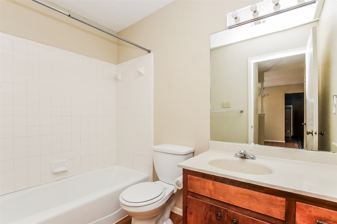1813 Rawhide Drive Round Rock, TX 78681 - Photo 15 of 16 a bathroom with a sink a toilet and a bathtub