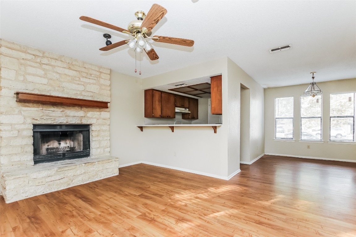 1813 Rawhide Drive Round Rock, TX 78681 - Photo 6 of 16 a view of empty room with wooden floor and fireplace