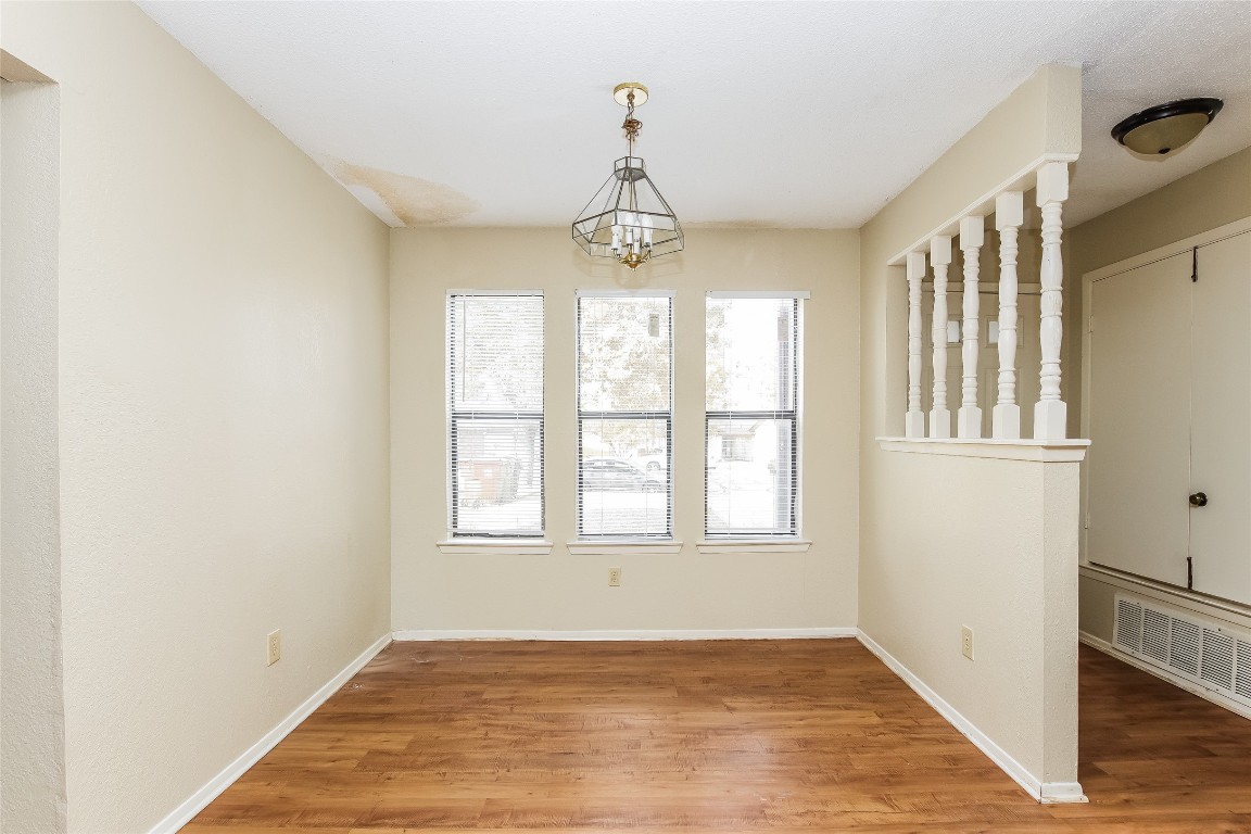 1813 Rawhide Drive Round Rock, TX 78681 - Photo 7 of 16 a view of an empty room with wooden floor and a window