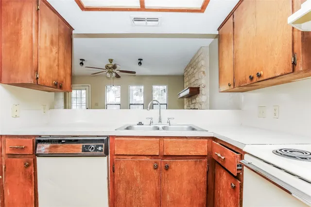 a kitchen with stainless steel appliances a sink and a stove