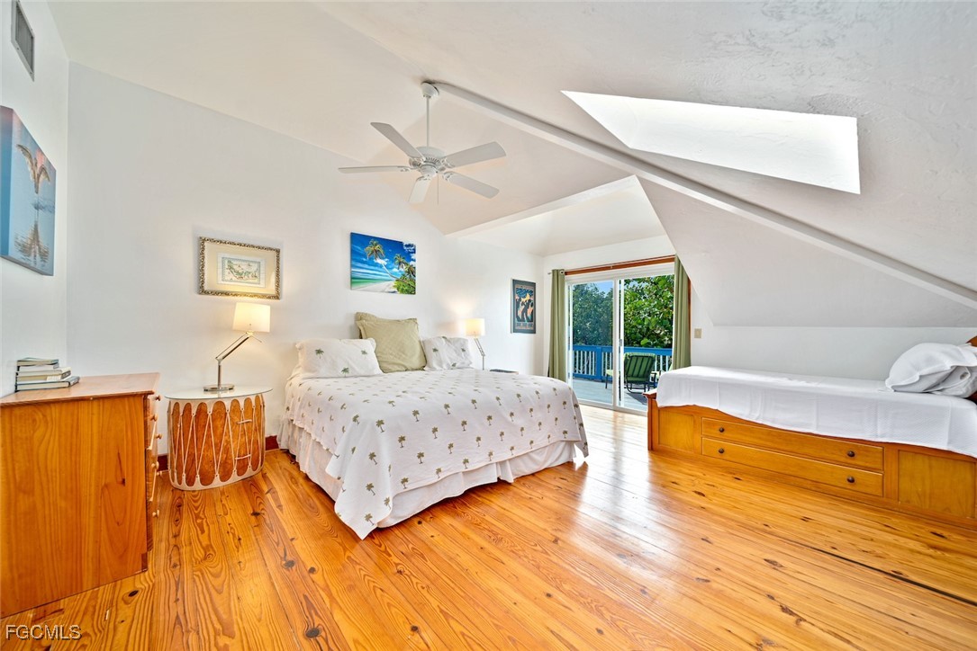 4546 Buck Key Road Sanibel, FL 33957 - Photo 15 of 41 a bedroom with a bed and wooden floor