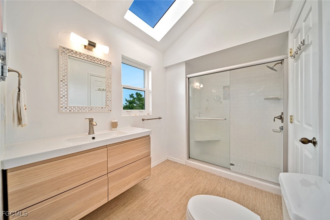 4546 Buck Key Road Sanibel, FL 33957 - Photo 17 of 41 a bathroom with a sink toilet a mirror and shower