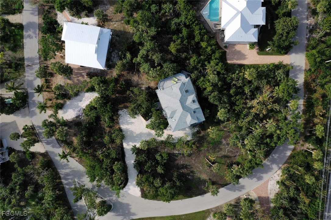 4546 Buck Key Road Sanibel, FL 33957 - Photo 40 of 41 an aerial view of a house with a yard and outdoor seating