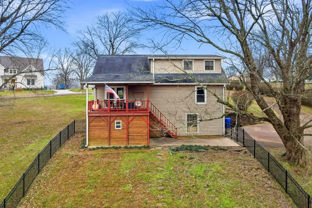 a view of a swimming pool with a house in the background