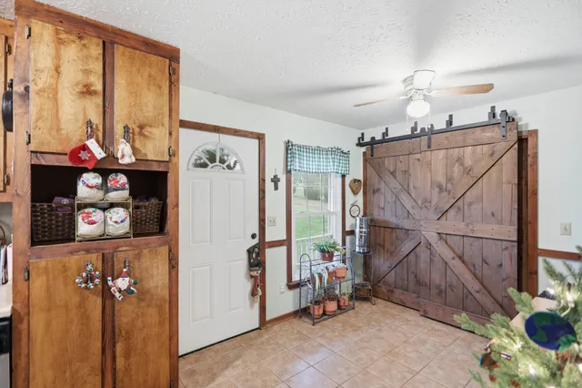 a spacious bedroom with a large bed and a chandelier
