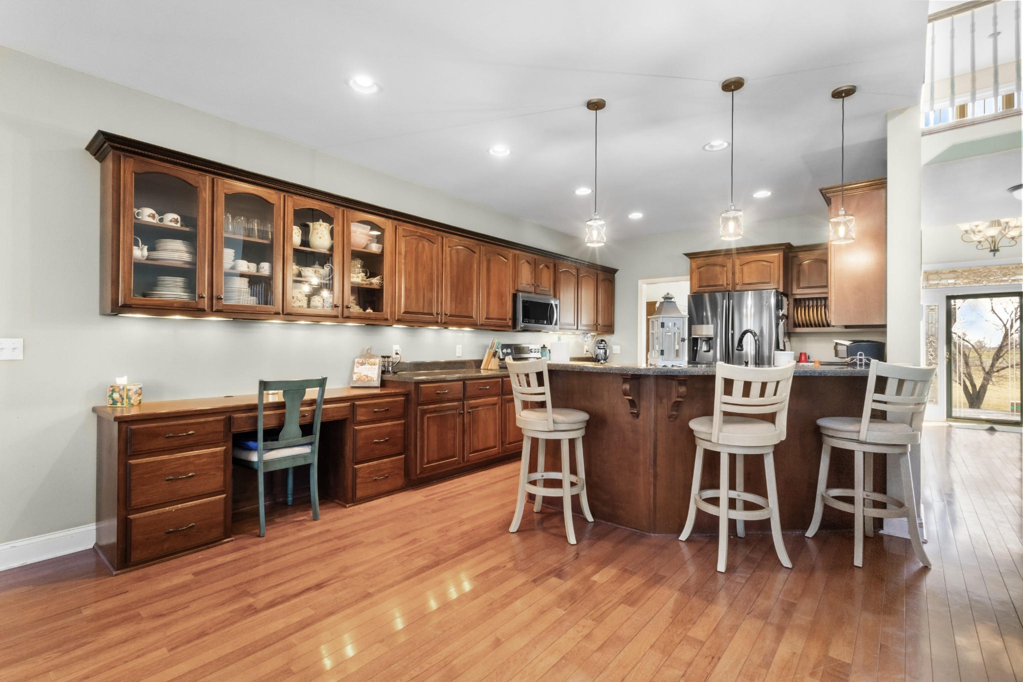 4591 Pineywoods Road Adams, TN 37010 - Photo 16 of 83 a kitchen with stainless steel appliances granite countertop a stove top oven a sink a dining table and chairs with wooden floor