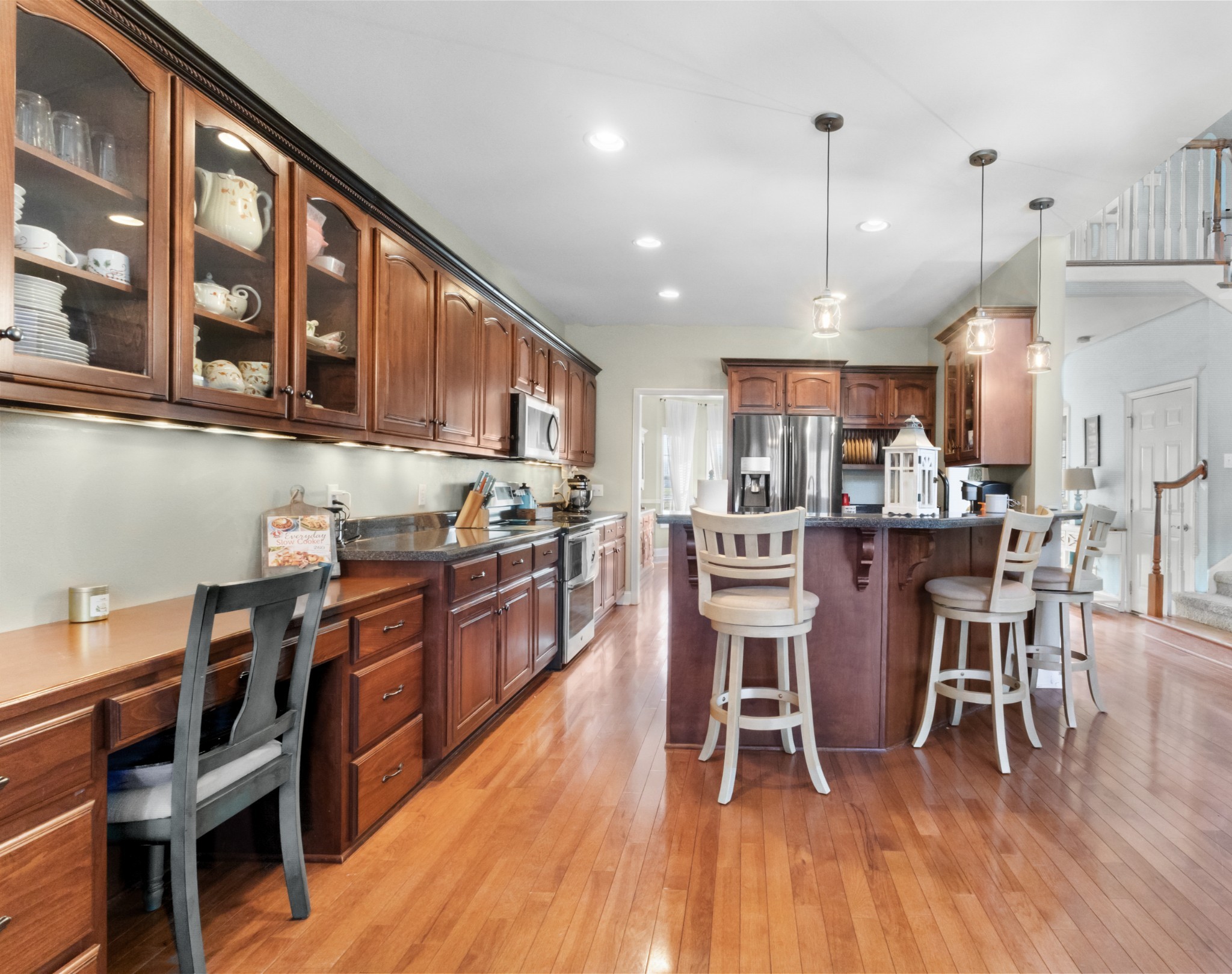 4591 Pineywoods Road Adams, TN 37010 - Photo 17 of 83 a open kitchen with stainless steel appliances granite countertop a table chairs sink and cabinets