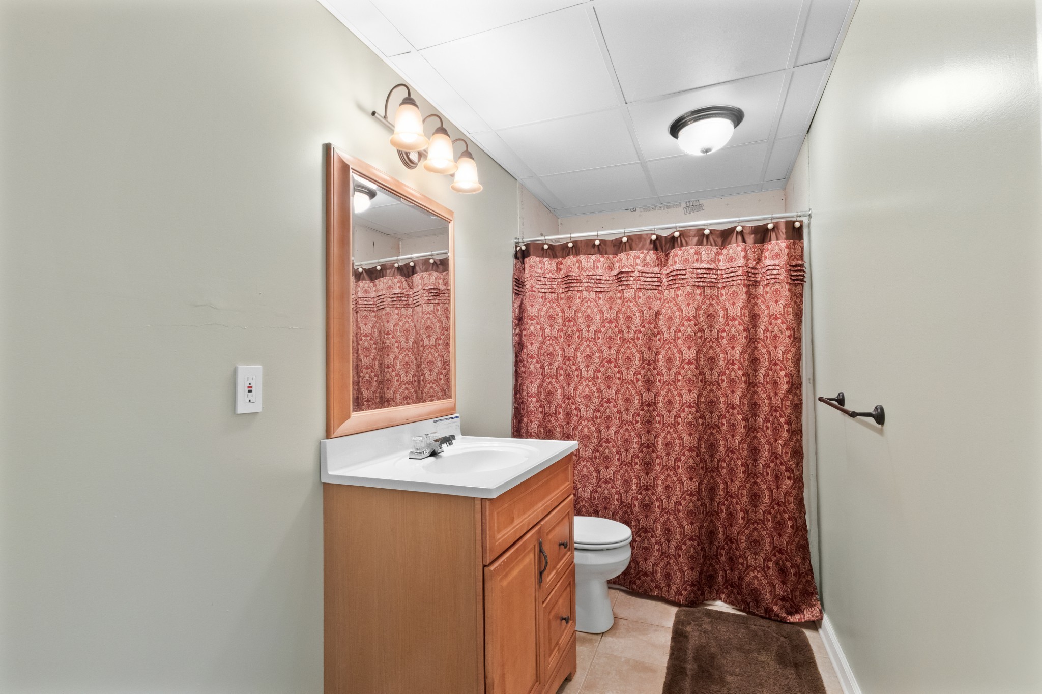 4591 Pineywoods Road Adams, TN 37010 - Photo 44 of 83 a bathroom with a sink a toilet and shower curtain