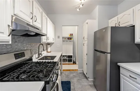 a kitchen with stainless steel appliances a refrigerator a stove and a sink
