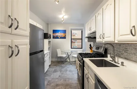 a kitchen that has a refrigerator and a sink