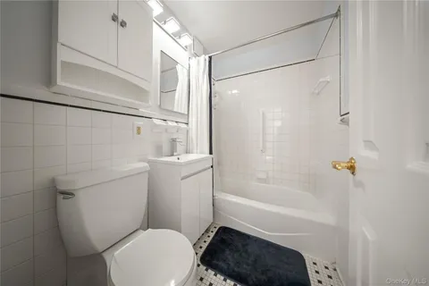 a bathroom with a toilet a sink and bathtub
