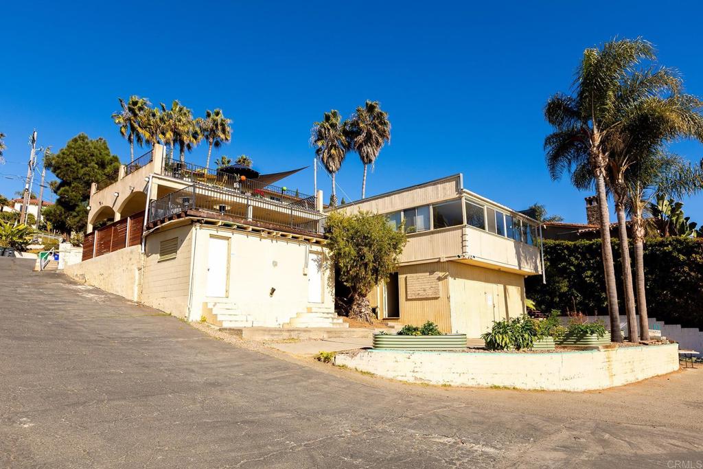 4509 Adams Street Carlsbad, CA 92008 - Photo 14 of 18 a front view of a house with a yard and a garage