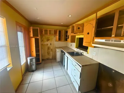 a kitchen with a refrigerator and a stove