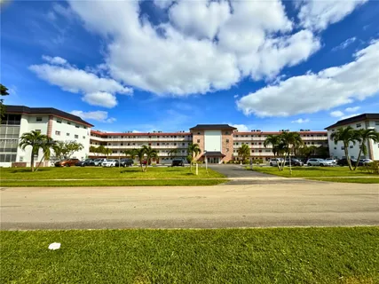 a view of a building in the middle of a big yard