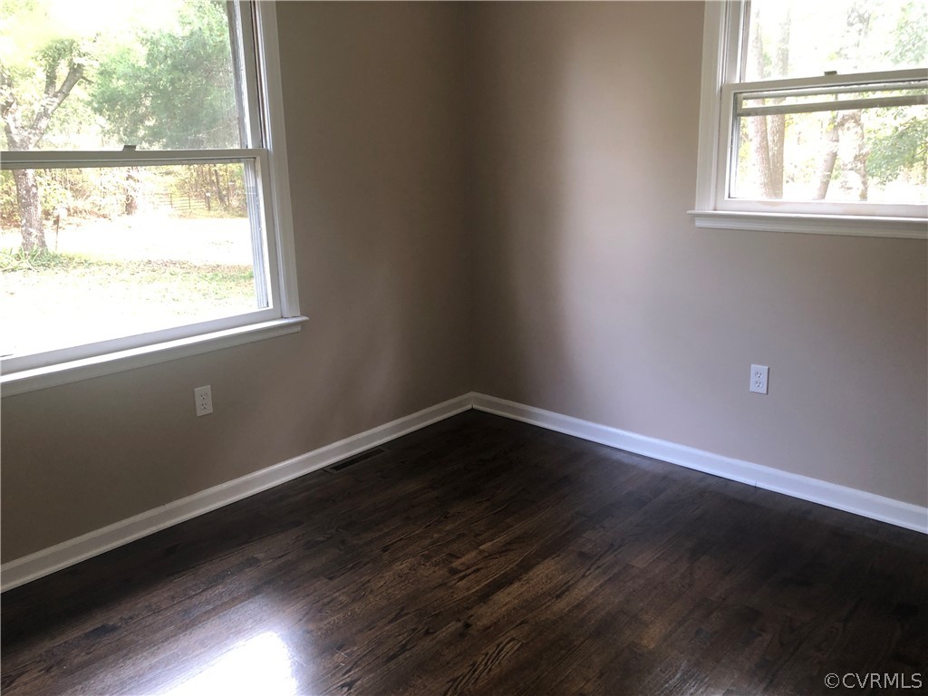 1813 Little Deer Road Alberta, VA 23821 - Photo 9 of 27 an empty room with wooden floor and windows