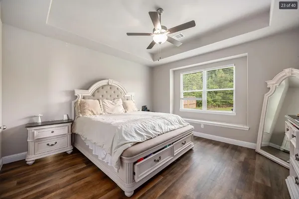 a spacious bathroom with a granite countertop double vanity sink a mirror and a toilet