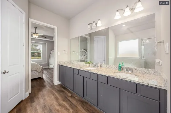 a bathroom with a tub a window and a glass door shower