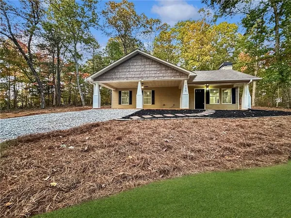 a front view of house with yard and green space