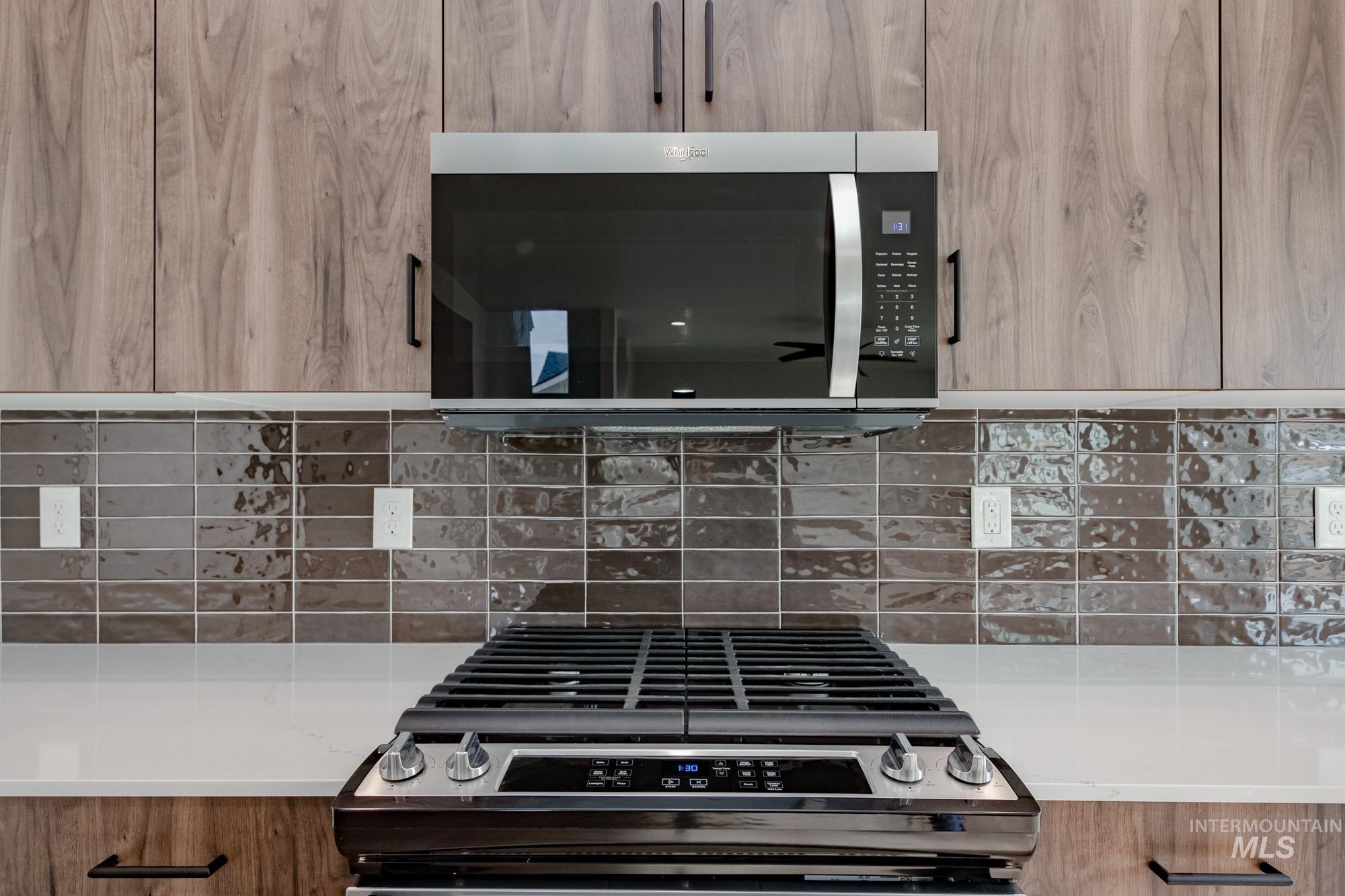 2135 South Border Way Meridian, ID 83642 - Photo 10 of 24 Kitchen view of modern cabinets, stainless steel appliances, and light stone countertops