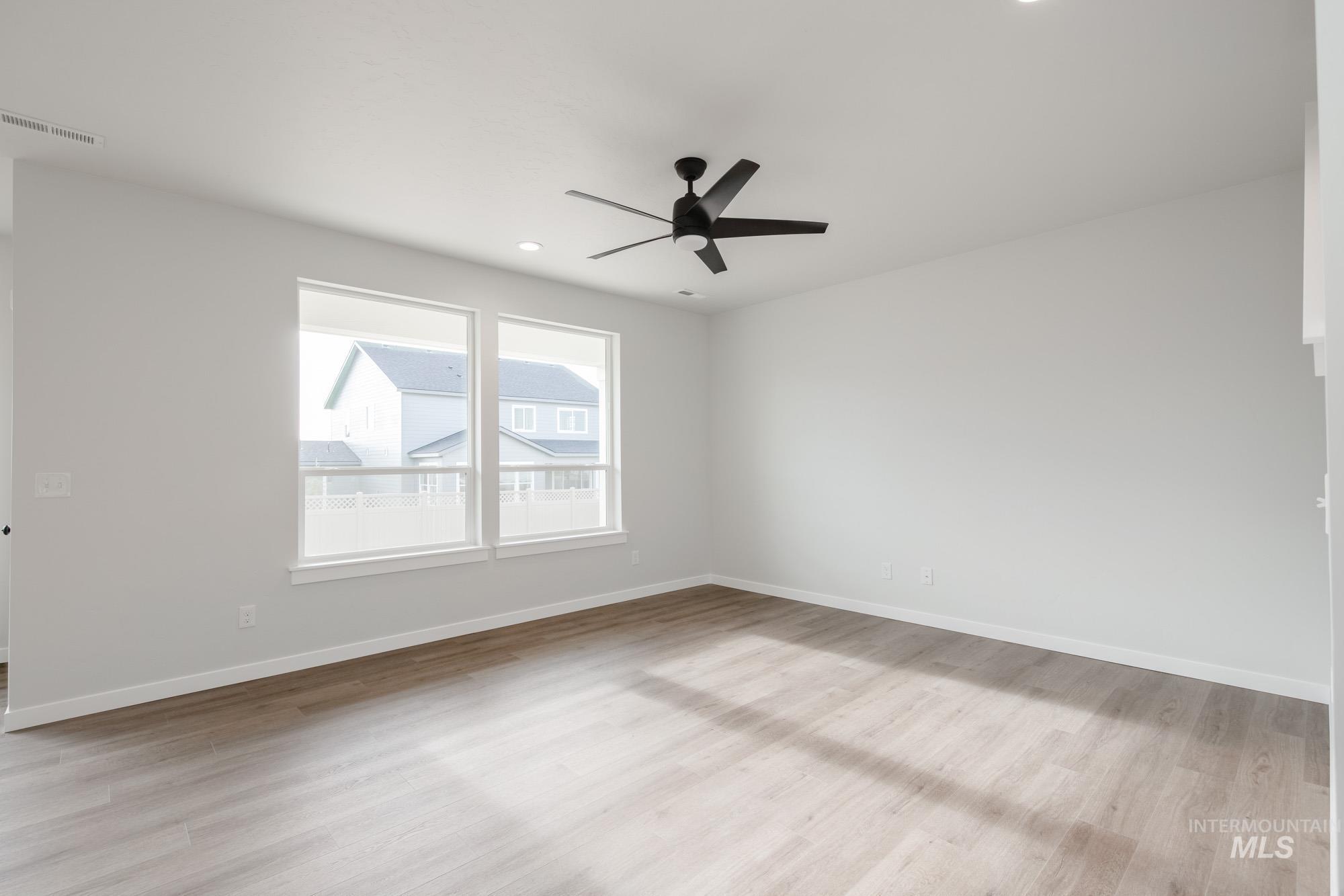 2135 South Border Way Meridian, ID 83642 - Photo 11 of 24 Unfurnished room featuring ceiling fan, light wood-type flooring, and recessed lighting