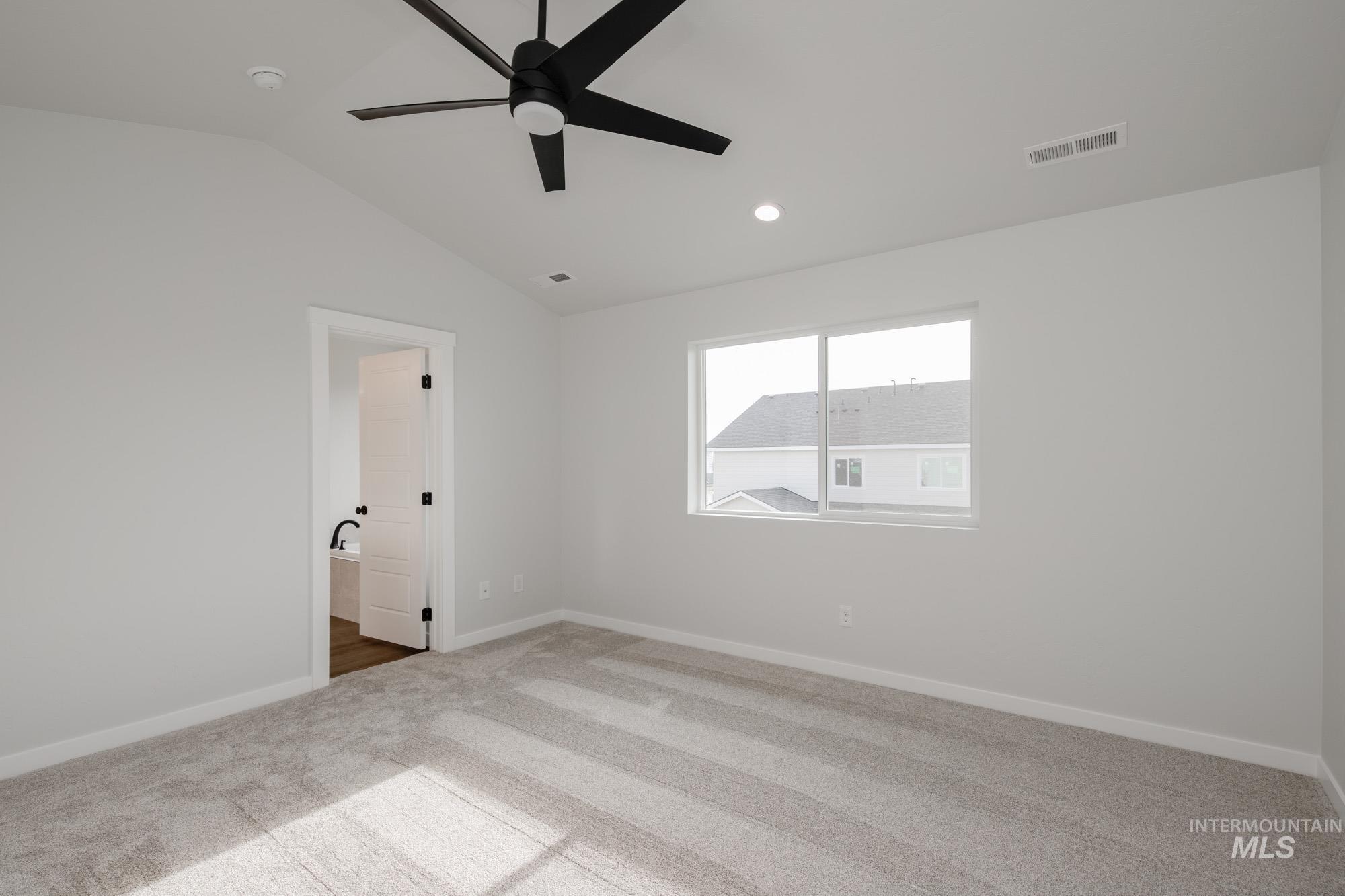 2135 South Border Way Meridian, ID 83642 - Photo 13 of 24 Spare room featuring carpet floors, vaulted ceiling, ceiling fan, and recessed lighting