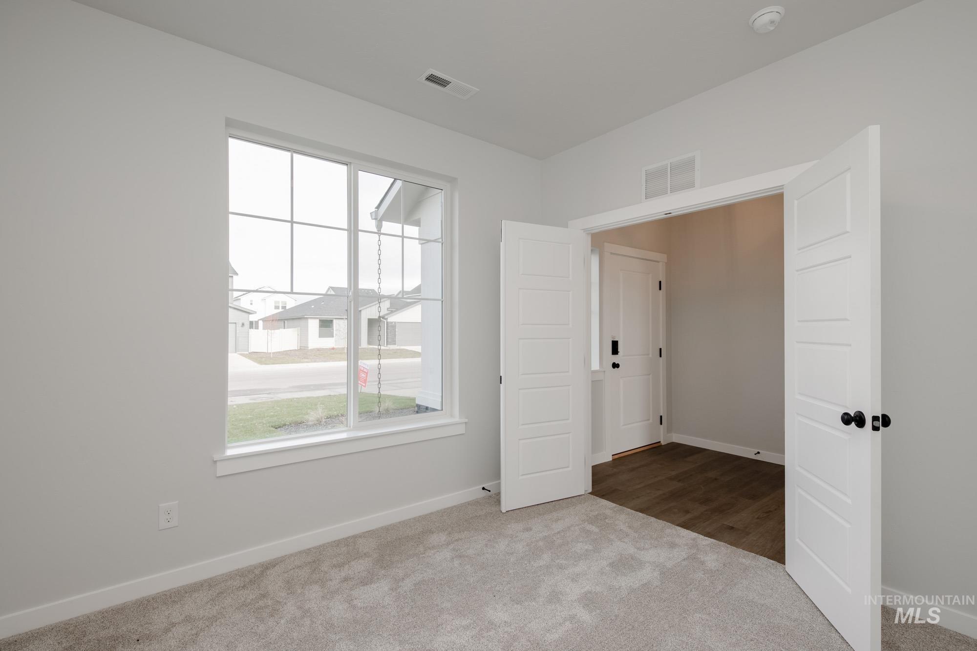 2135 South Border Way Meridian, ID 83642 - Photo 2 of 24 Spare room featuring carpet floors and baseboards