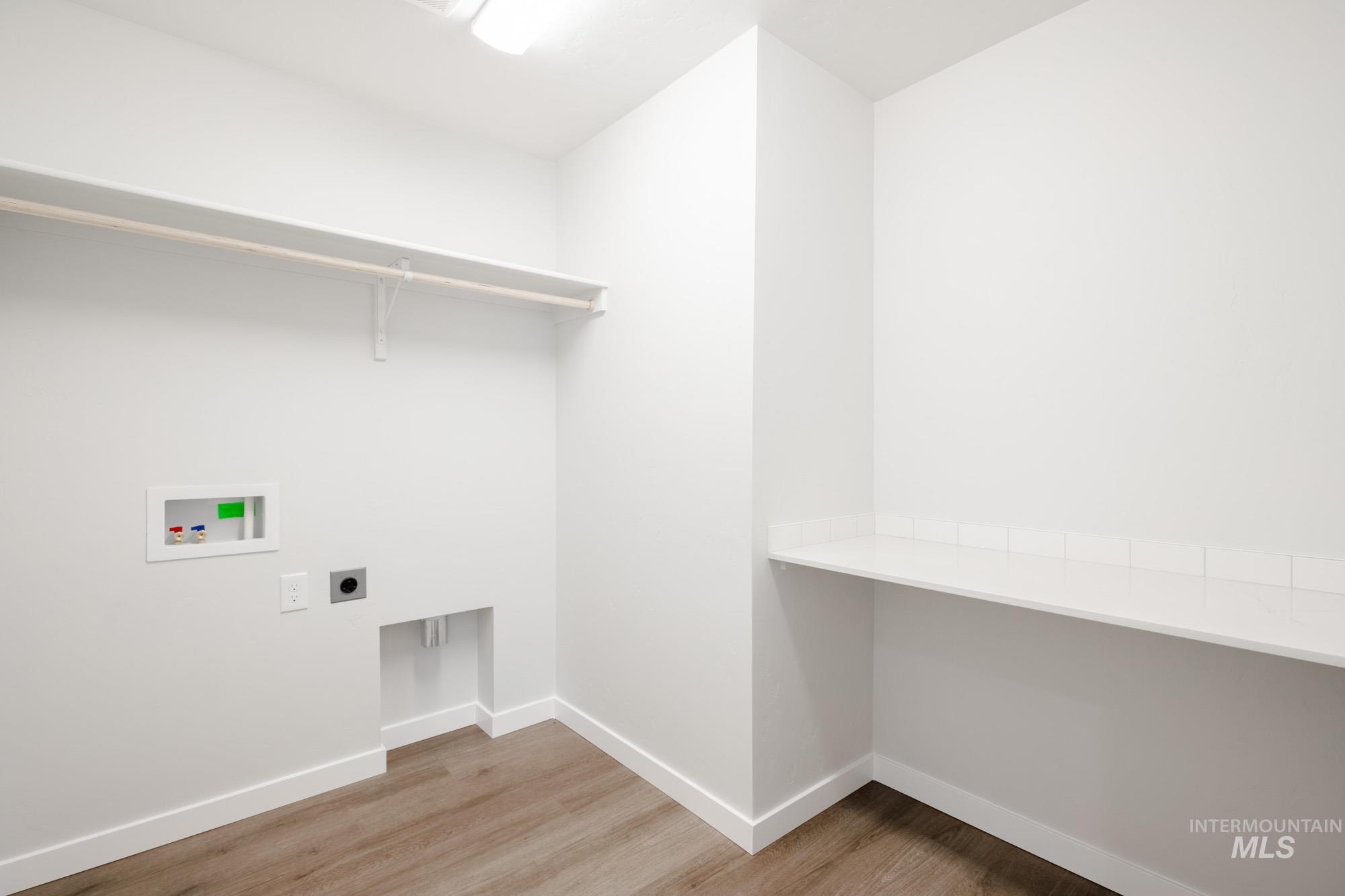 2135 South Border Way Meridian, ID 83642 - Photo 19 of 24 Laundry area featuring electric dryer hookup, light wood-type flooring, and hookup for a washing machine